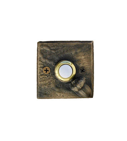 Square bronze doorbell plate with acorn in lower right corner