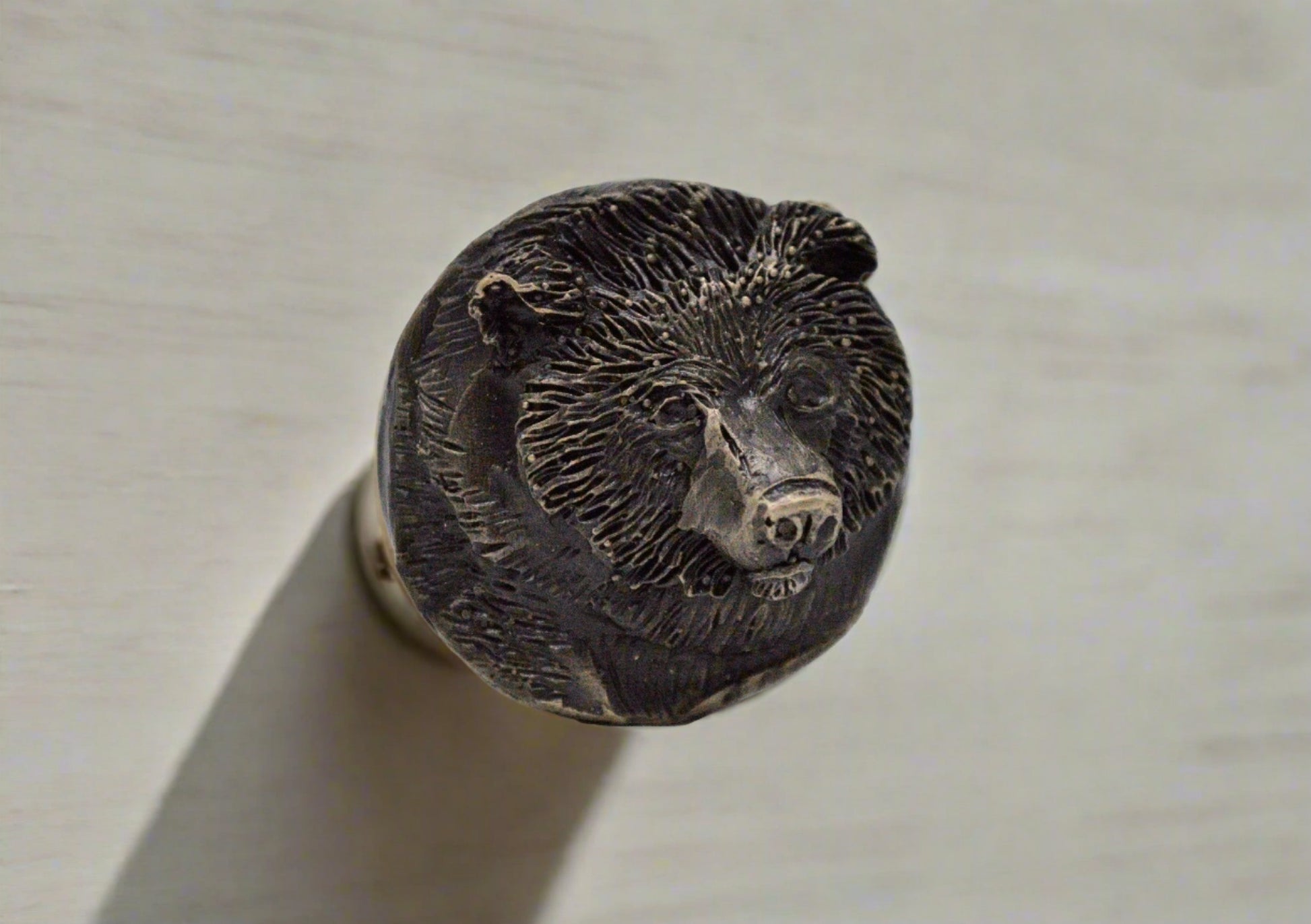 Cabinet knob made of bronze with bear face.